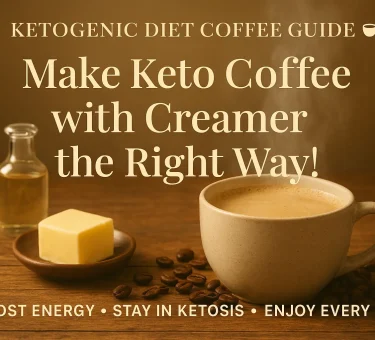 Steaming cup of creamy keto coffee with creamer on a rustic wooden table surrounded by butter, MCT oil, and coffee beans